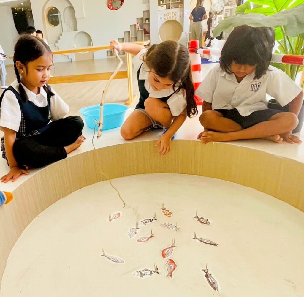 K3 students learning literacy through play.